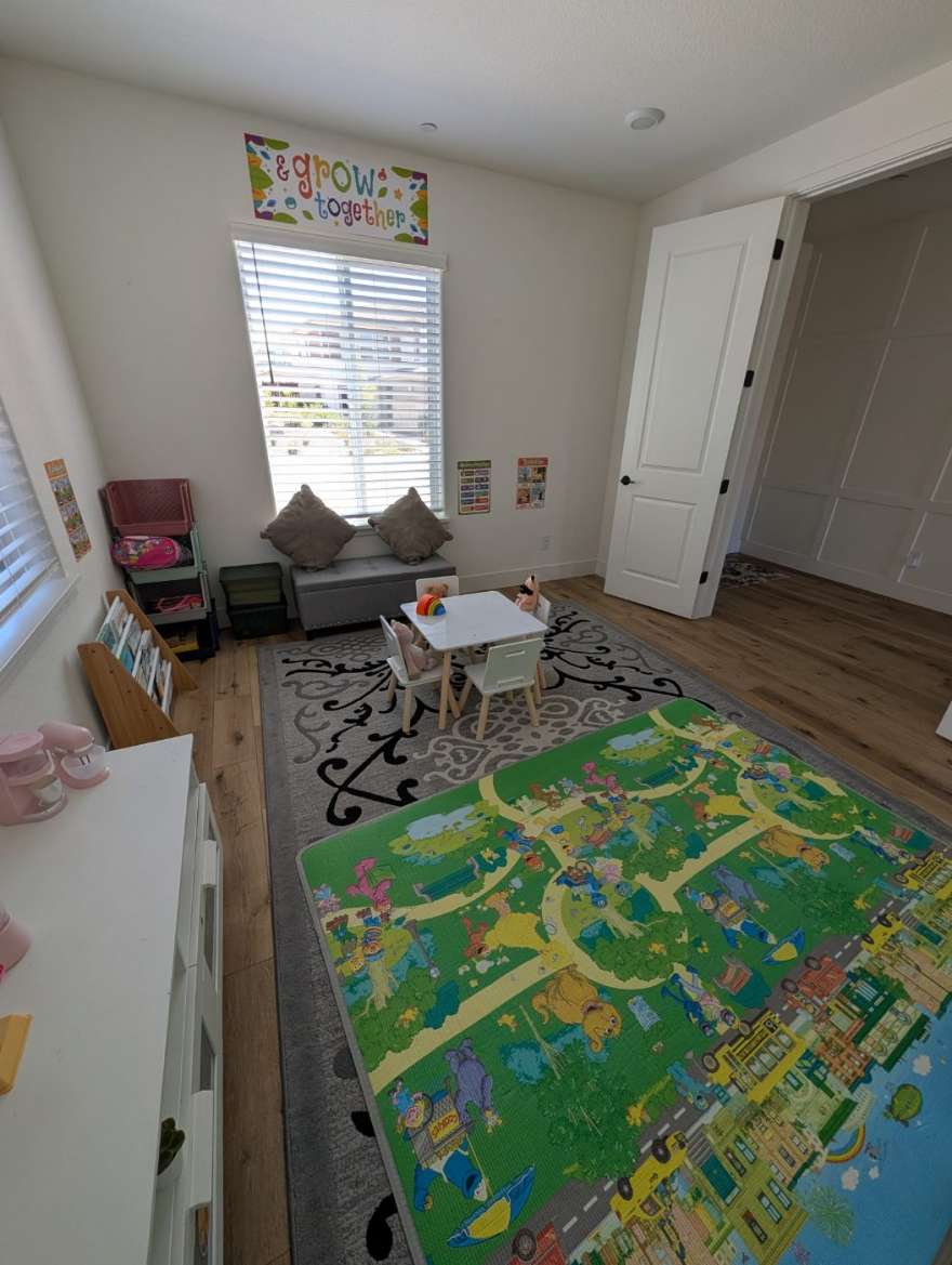 The playroom: learning table, low book shelf, window bench, and play mat